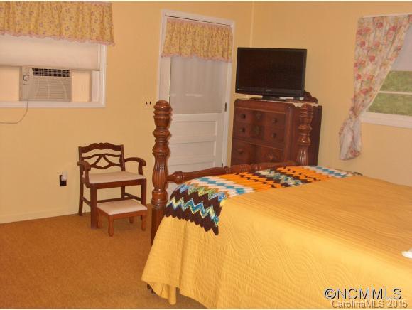 55 Holstein Farm Road Waynesville, NC 28785 - Photo 13 of 24 a bedroom with a bed and flat screen tv