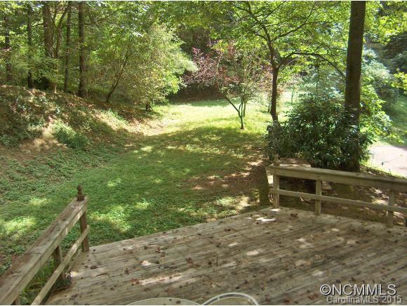 55 Holstein Farm Road Waynesville, NC 28785 - Photo 21 of 24 a view of a yard with plants and a bench