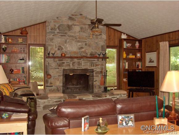 55 Holstein Farm Road Waynesville, NC 28785 - Photo 6 of 24 a living room with furniture a fireplace and a flat screen tv