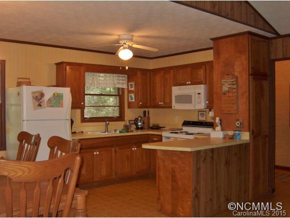 55 Holstein Farm Road Waynesville, NC 28785 - Photo 9 of 24 a kitchen with a sink and a refrigerator
