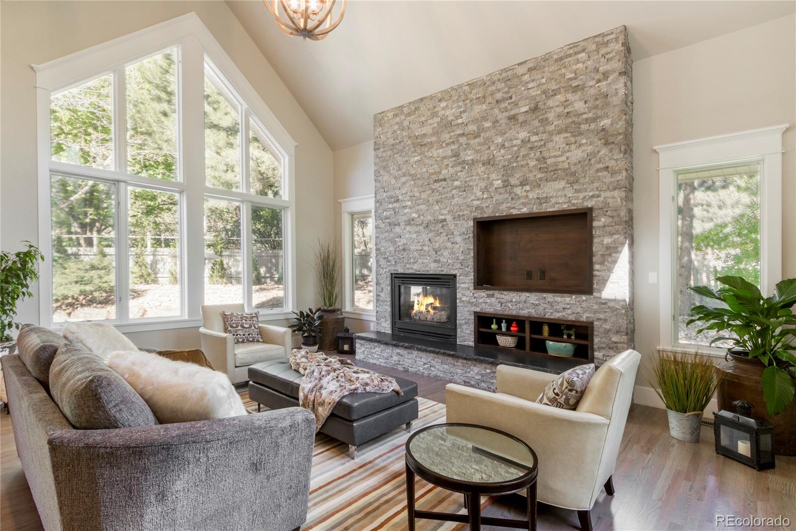 a living room with furniture flat screen tv and a fireplace