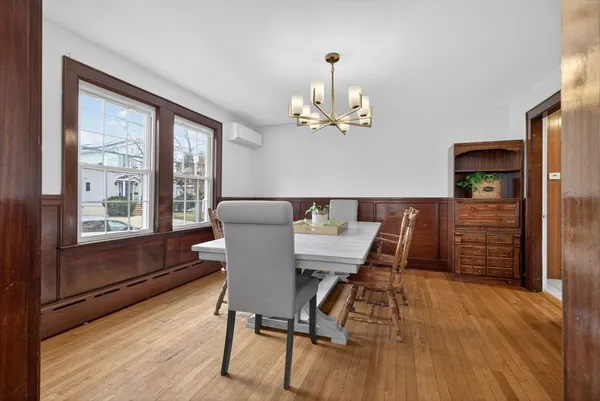 a view of a dining room with furniture window and wooden floor