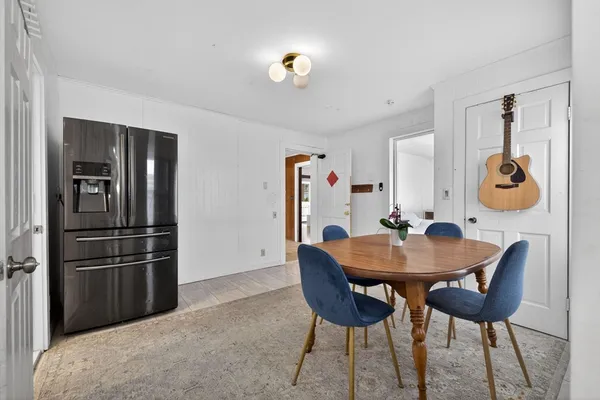 a view of a room with furniture and wooden floor