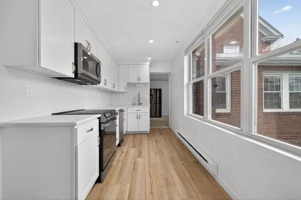 a kitchen with stainless steel appliances granite countertop a stove and a refrigerator