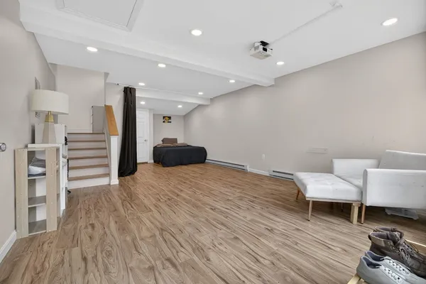 a view of a room with furniture and wooden floor