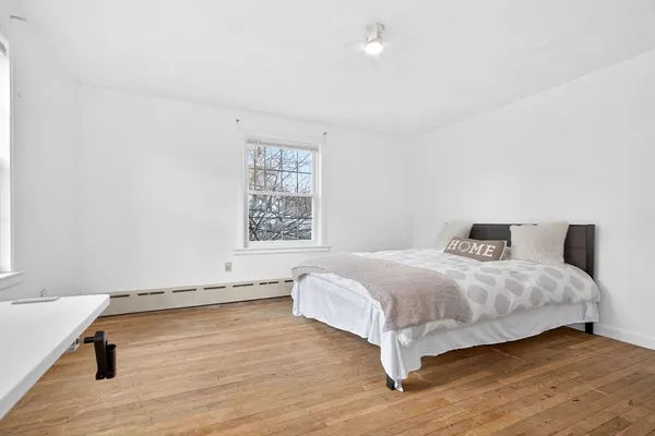 a bedroom with a bed and window