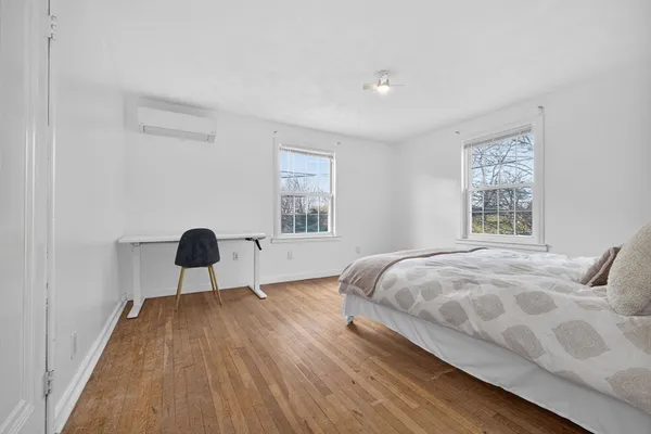 a bedroom with a bed and a large window