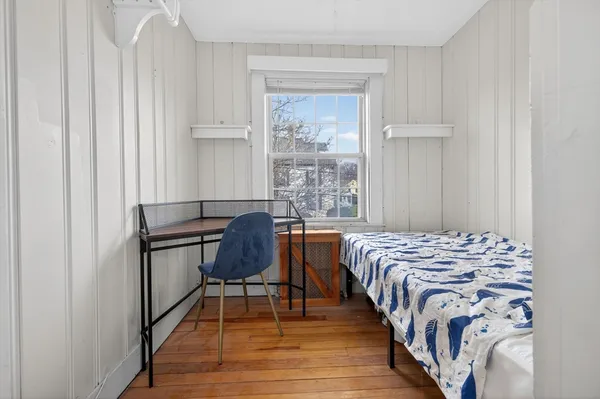 a bedroom with a bed and a window