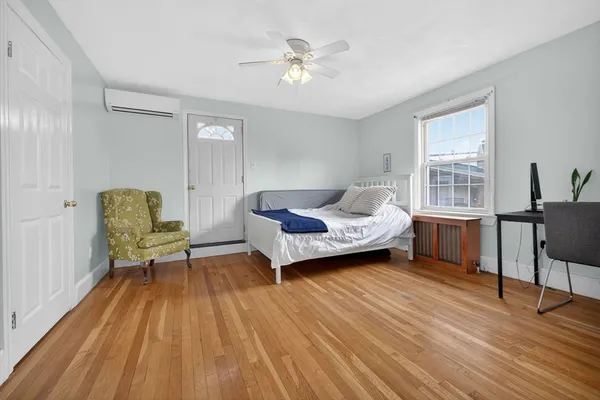 a living room with a bed furniture and a window