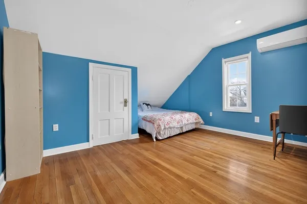 a bedroom with a bed and a chair