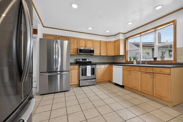 a kitchen with stainless steel appliances granite countertop a refrigerator sink and cabinets