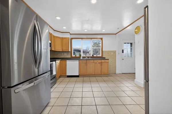 a kitchen with granite countertop a refrigerator and a sink