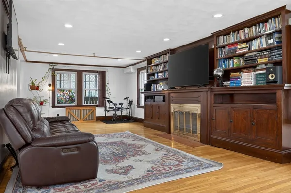 a living room with fireplace furniture and a flat screen tv