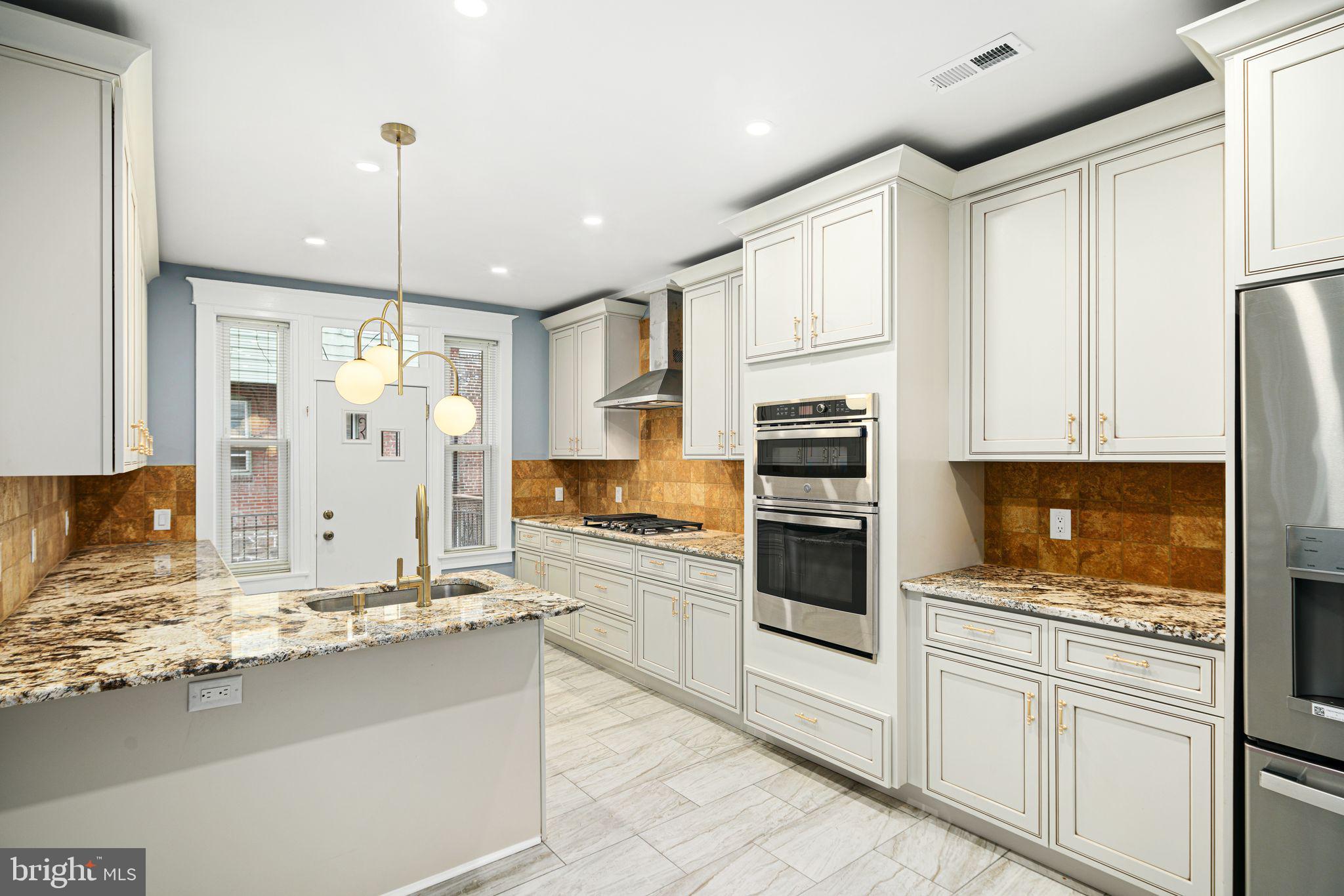 452 South 48th Street Philadelphia, PA 19143 - Photo 1 of 60 a kitchen with granite countertop white cabinets and appliances