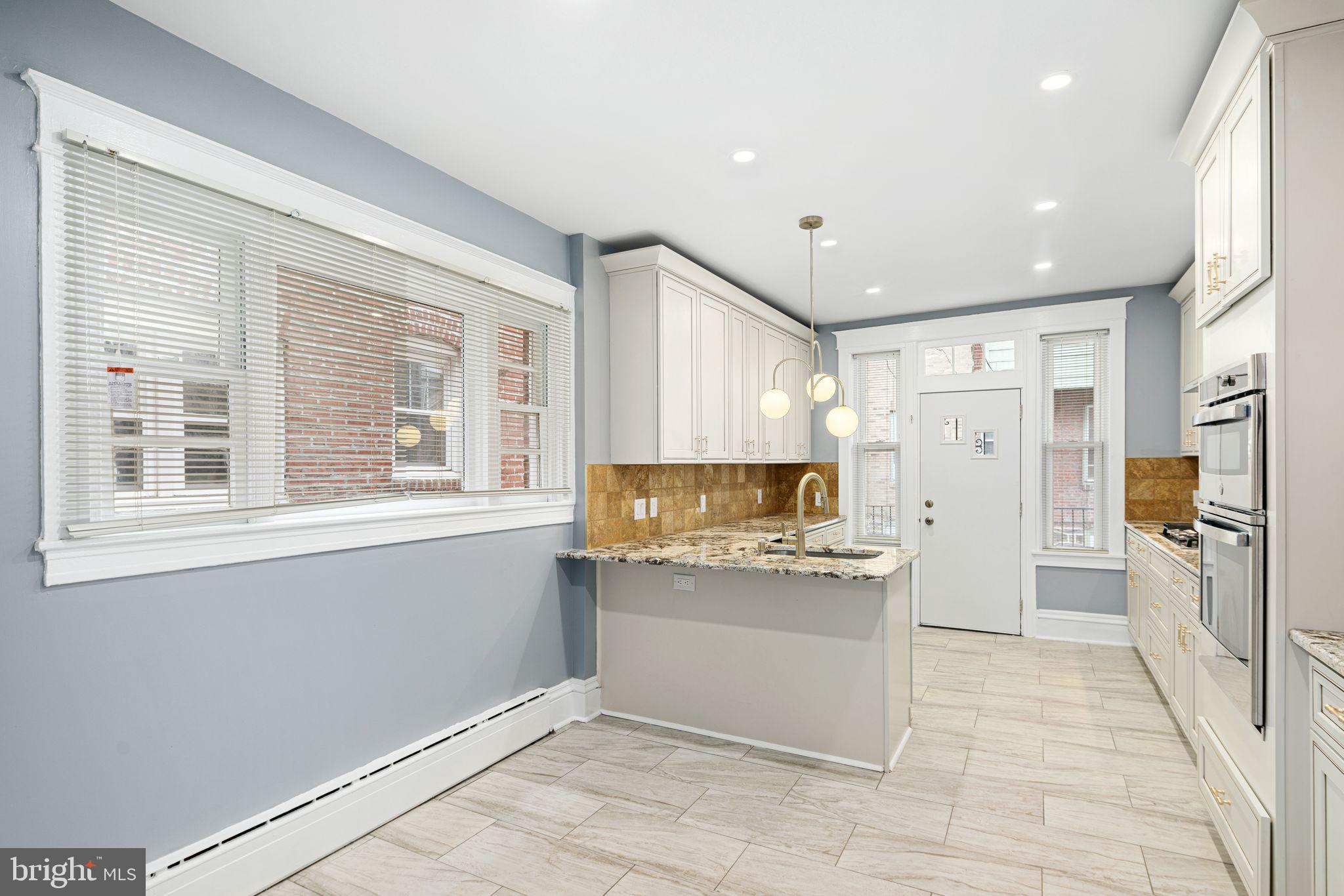 452 South 48th Street Philadelphia, PA 19143 - Photo 11 of 60 a kitchen with a refrigerator and a sink