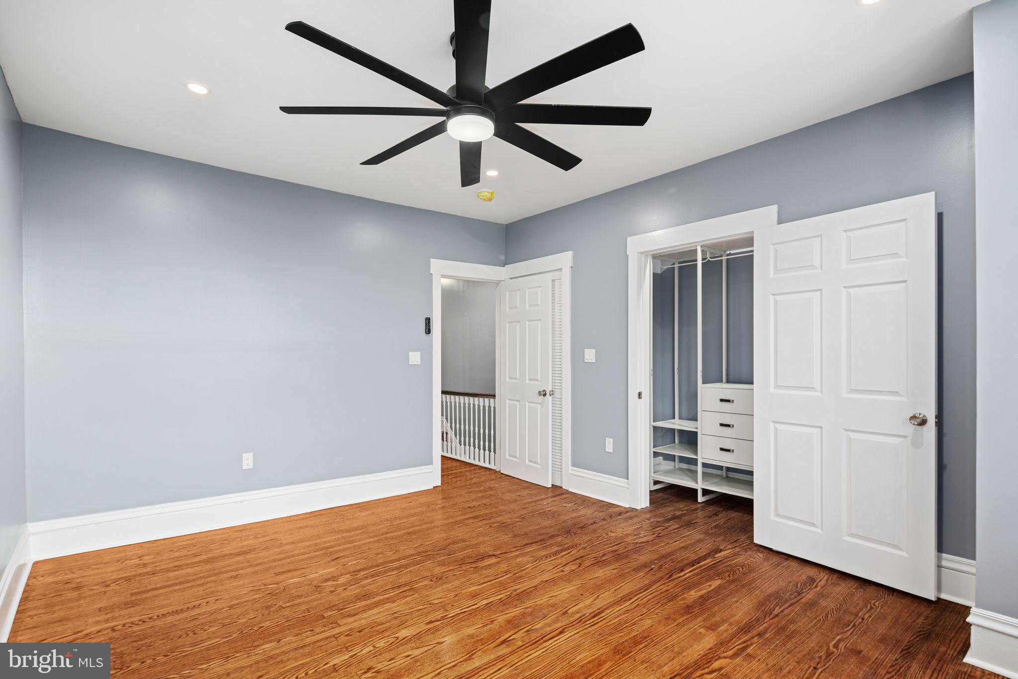 452 South 48th Street Philadelphia, PA 19143 - Photo 38 of 60 an empty room with wooden floor ceiling fan and windows