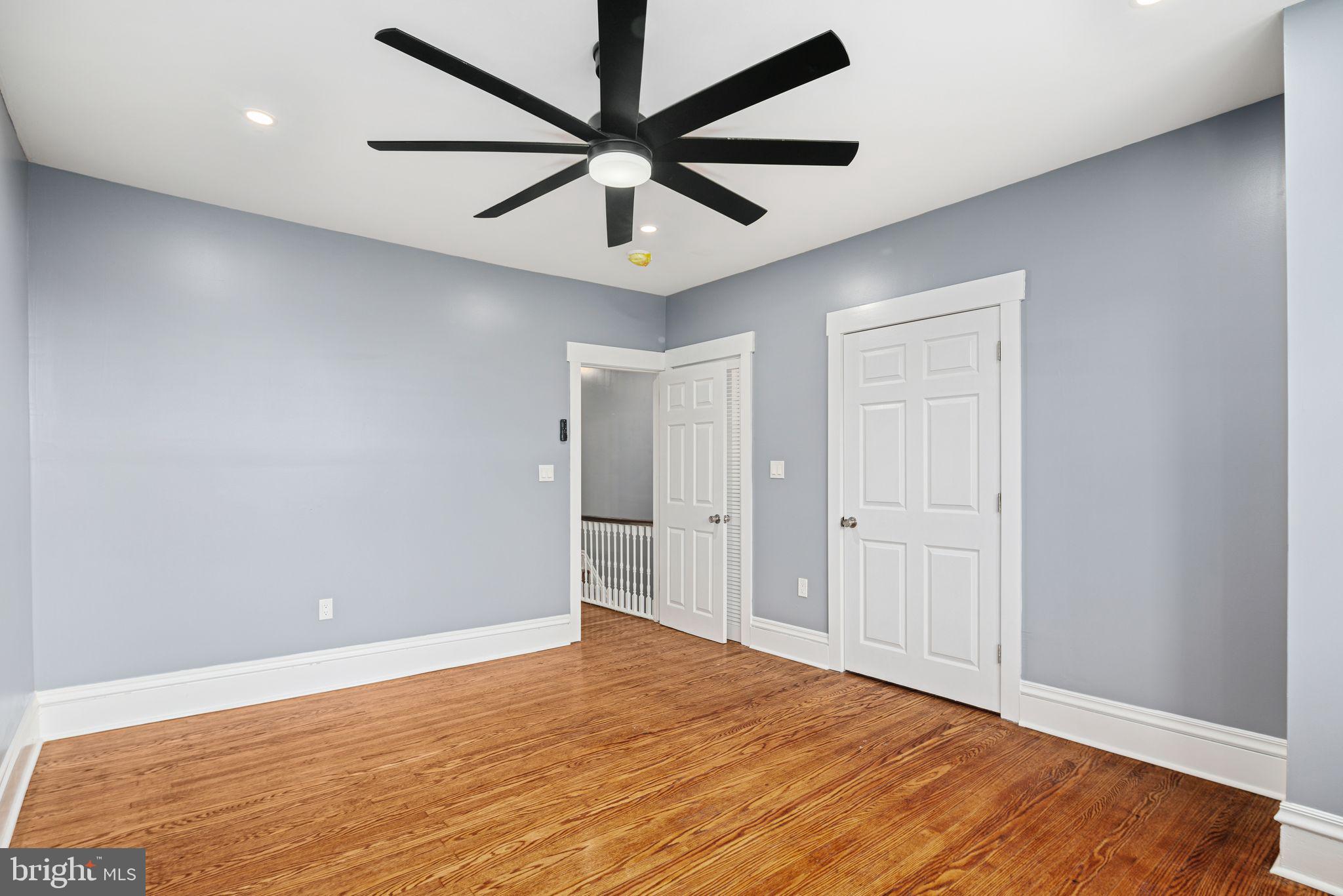 452 South 48th Street Philadelphia, PA 19143 - Photo 40 of 60 an empty room with wooden floor ceiling fan and windows