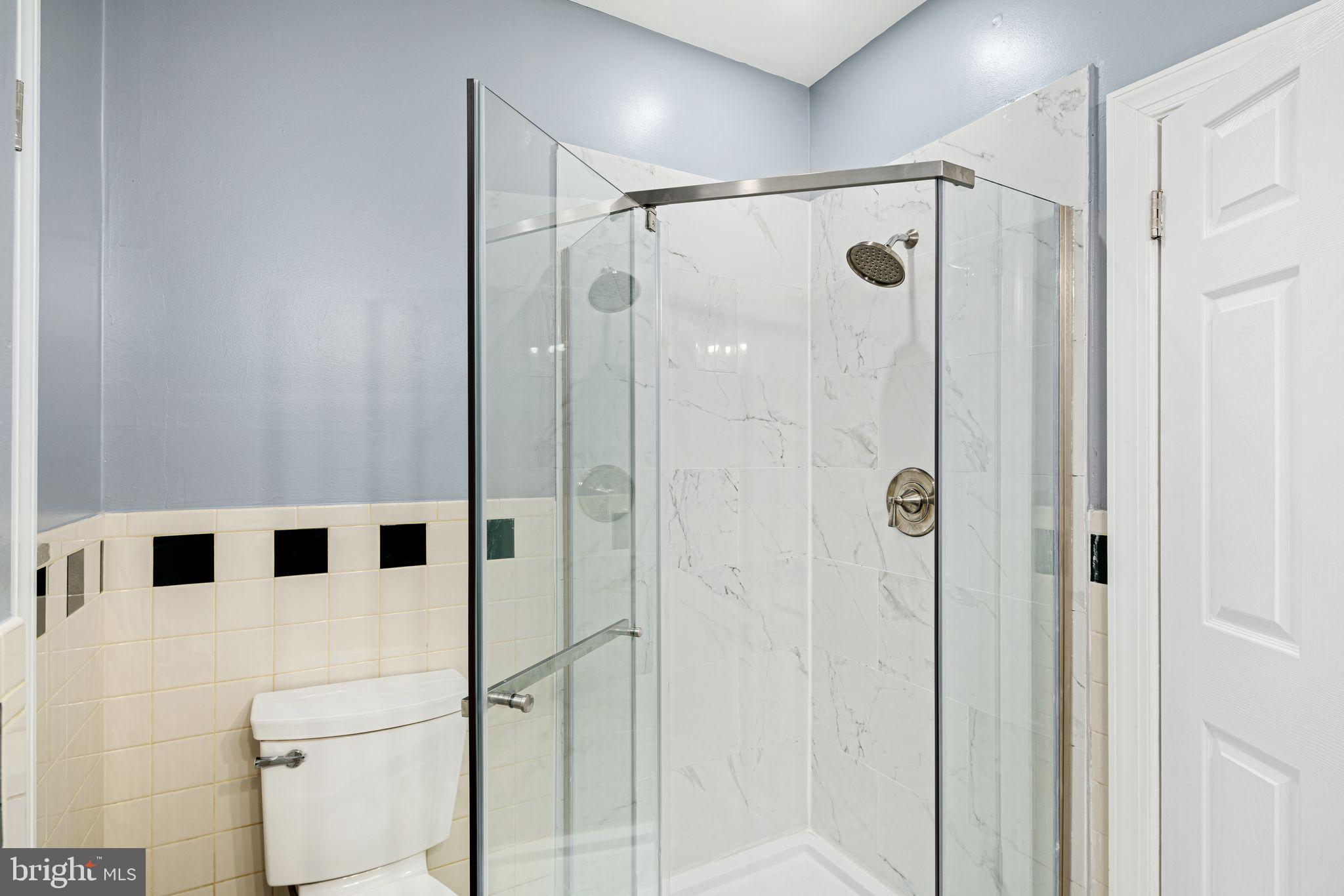 452 South 48th Street Philadelphia, PA 19143 - Photo 41 of 60 a bathroom with a shower and a glass door