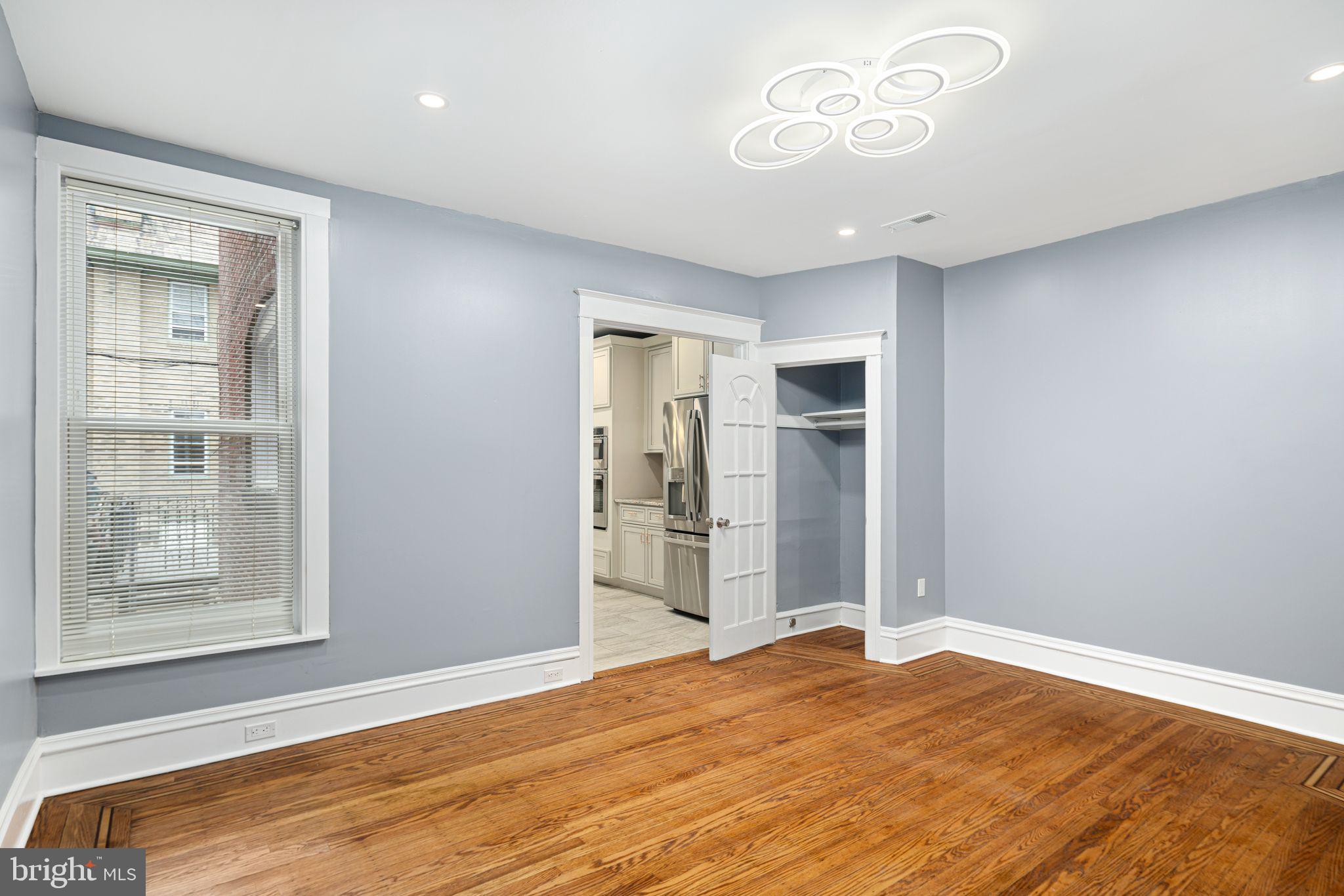 452 South 48th Street Philadelphia, PA 19143 - Photo 44 of 60 a view of an empty room with wooden floor and a window