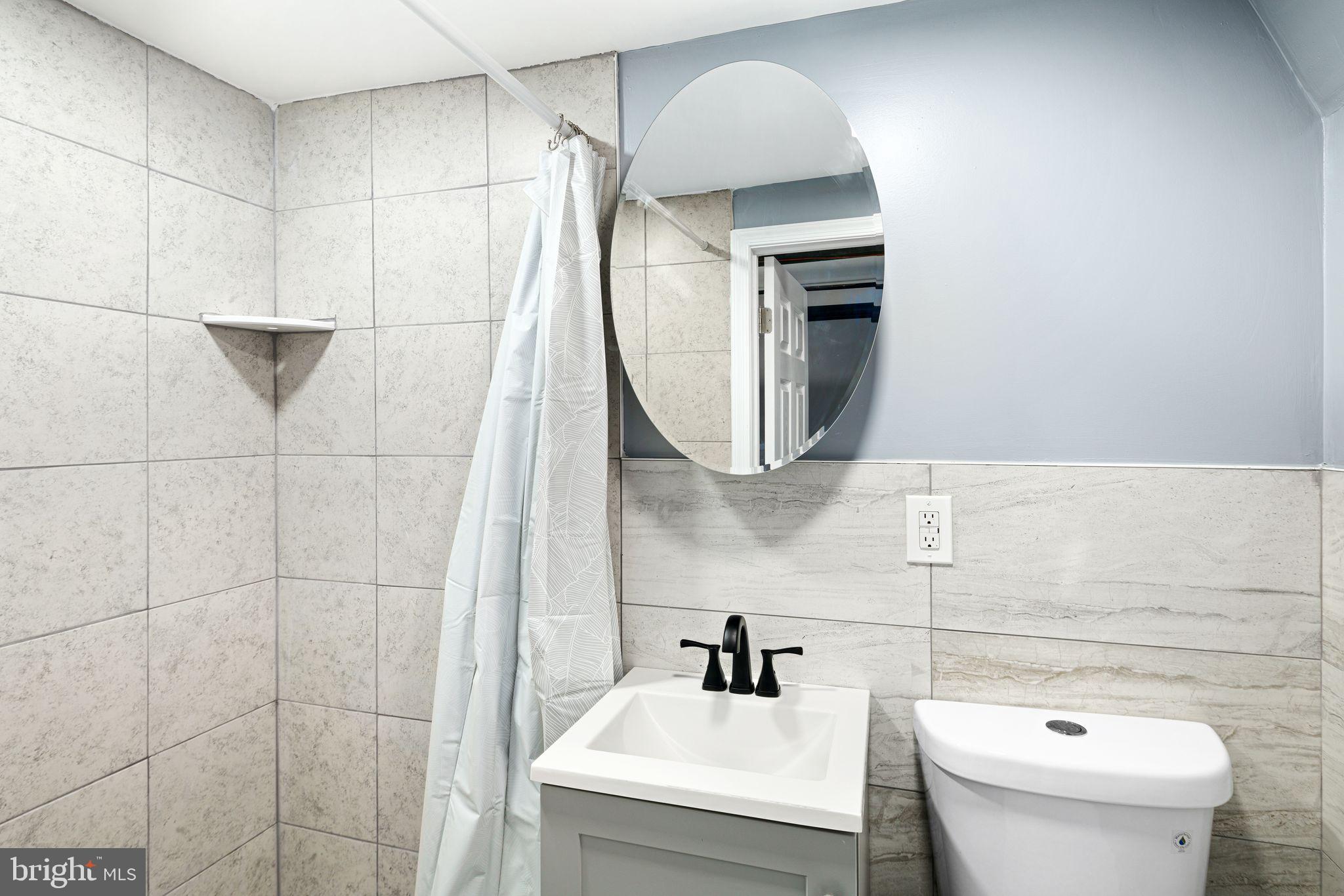 452 South 48th Street Philadelphia, PA 19143 - Photo 53 of 60 a bathroom with a sink toilet and mirror
