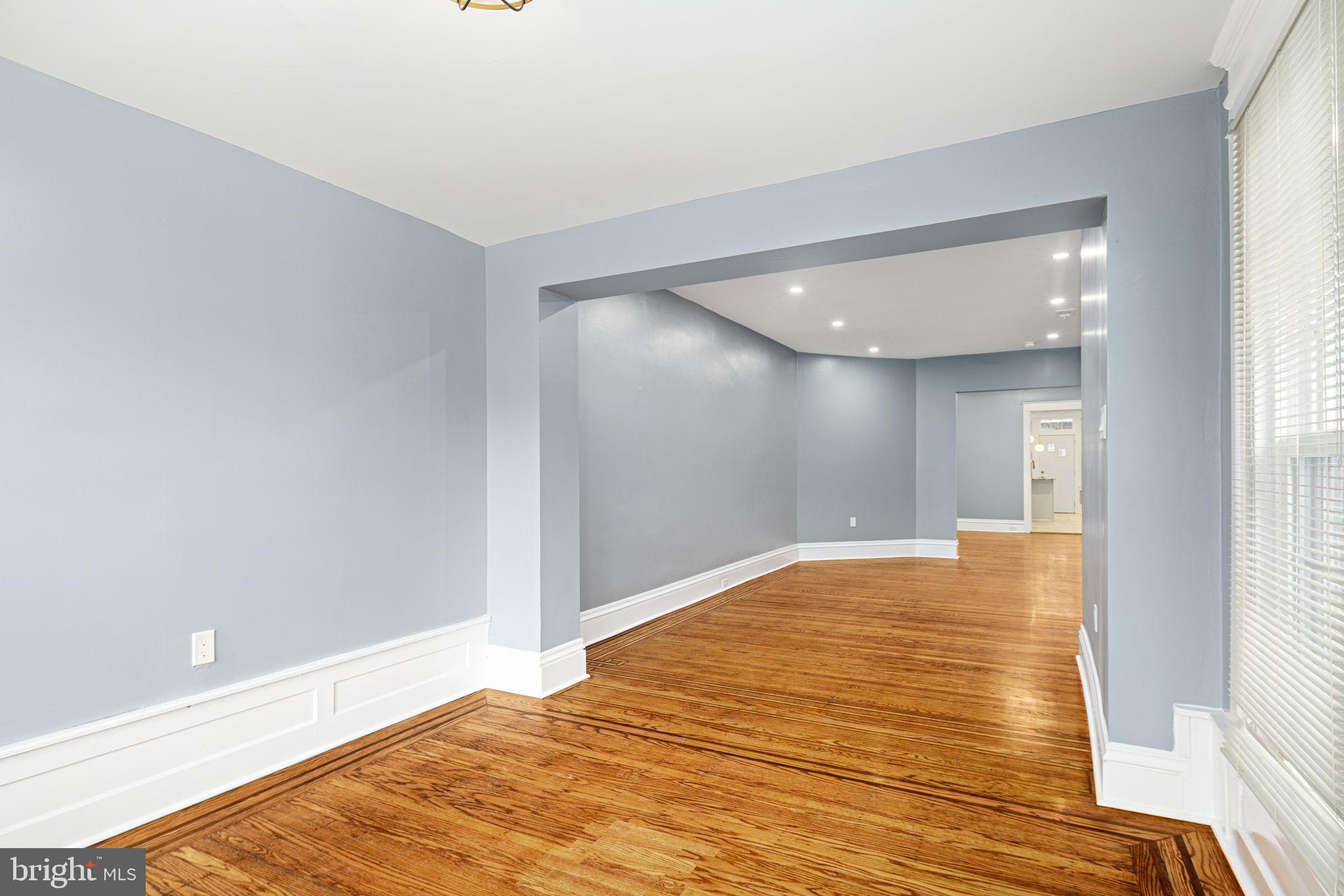 452 South 48th Street Philadelphia, PA 19143 - Photo 7 of 60 a view of an empty room with wooden floor and a window