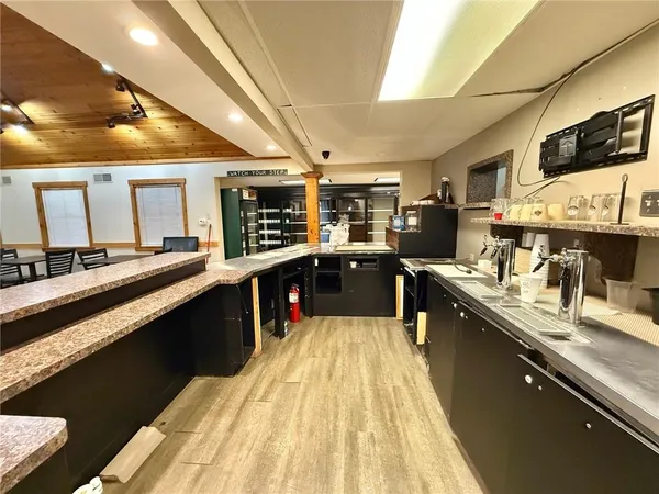 a large kitchen with stainless steel appliances and a sink