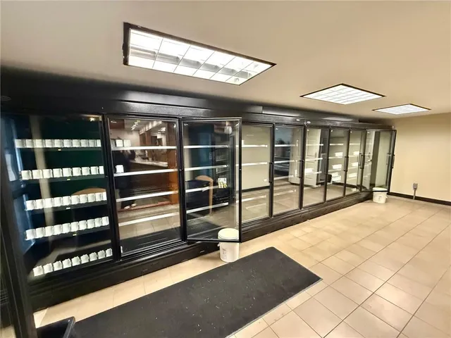 a kitchen with stainless steel appliances granite countertop a sink and a refrigerator