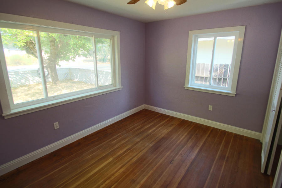 4569 Cedars Road Redding, CA 96001 - Photo 11 of 22 a view of an empty room with wooden floor and a window