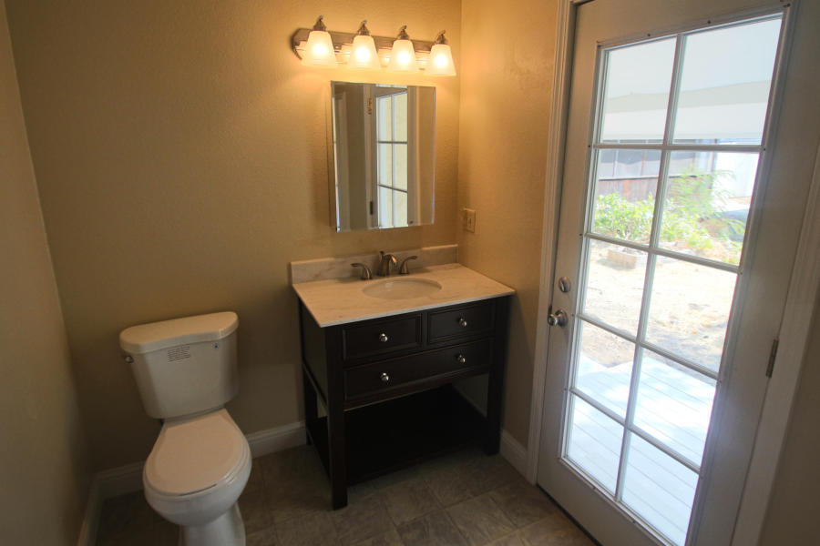 4569 Cedars Road Redding, CA 96001 - Photo 17 of 22 a bathroom with a toilet sink and mirror