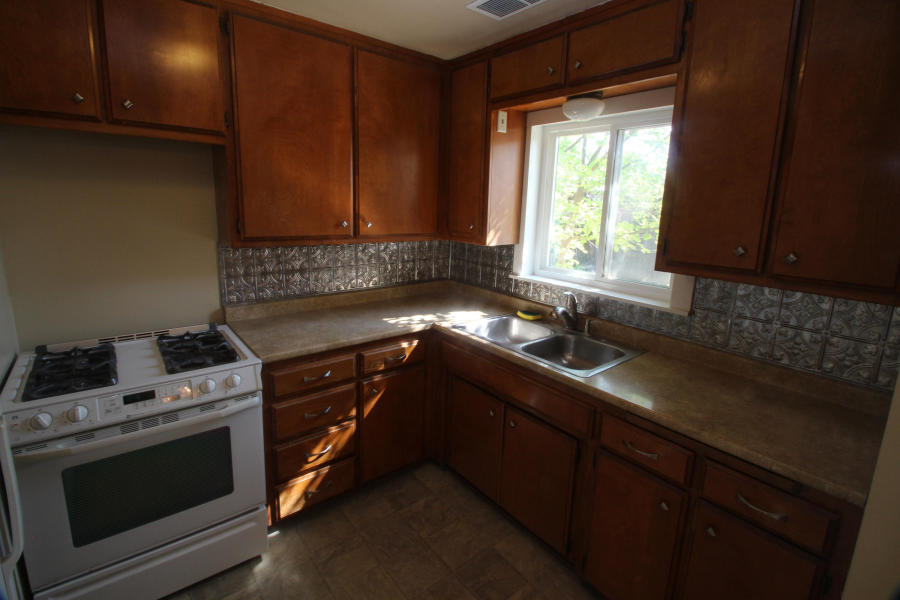 4569 Cedars Road Redding, CA 96001 - Photo 3 of 22 a kitchen with a sink stove and microwave