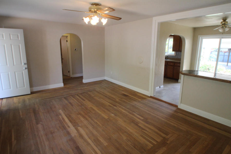4569 Cedars Road Redding, CA 96001 - Photo 9 of 22 a view of a livingroom with wooden floor and a ceiling fan