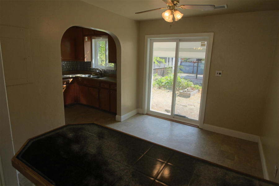 4569 Cedars Road Redding, CA 96001 - Photo 10 of 22 a front view of a house with a floor to ceiling window and a potted plant