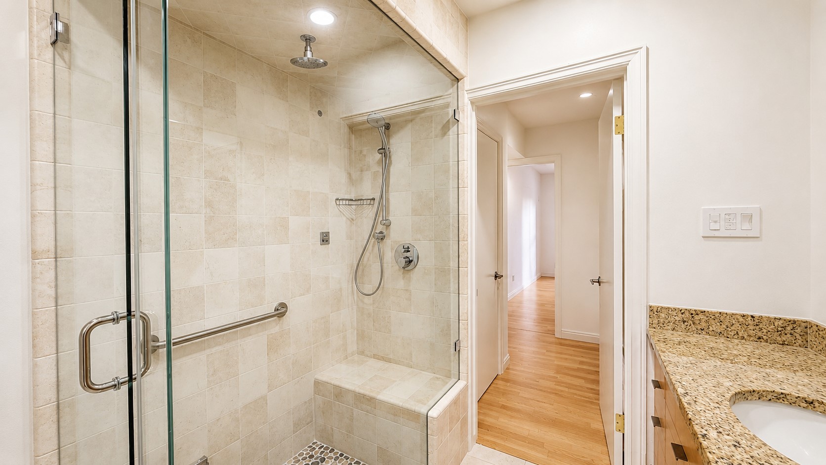 405 Ridgewood Road Austin, TX 78746 - Photo 11 of 22 Shower with glass enclosure, rain shower head, handheld shower, built-in bench, and grab bar