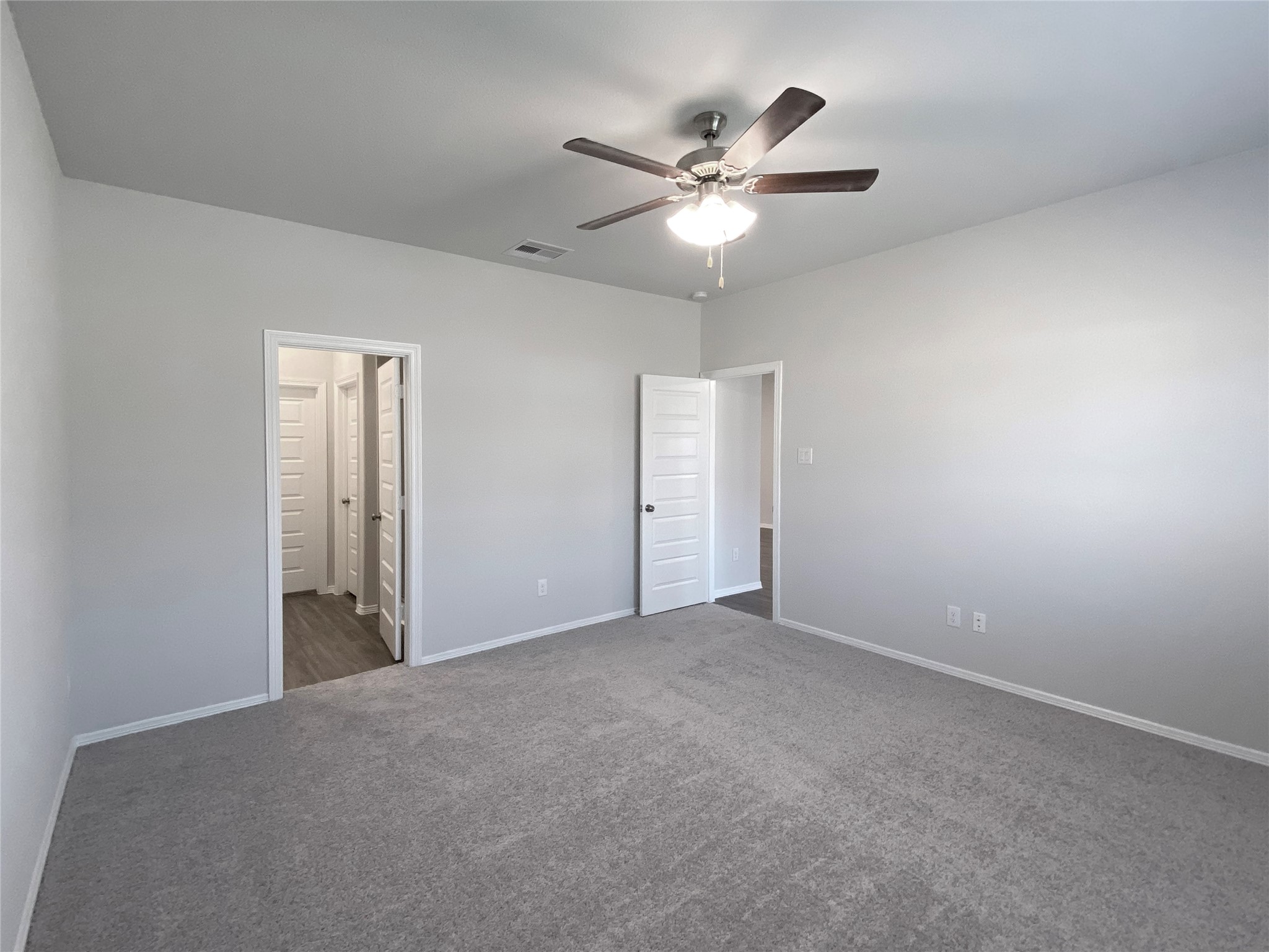 23338 Spring Genesis Lane Katy, TX 77493 - Photo 11 of 18 Large master bedroom with ceiling fan and bath suite