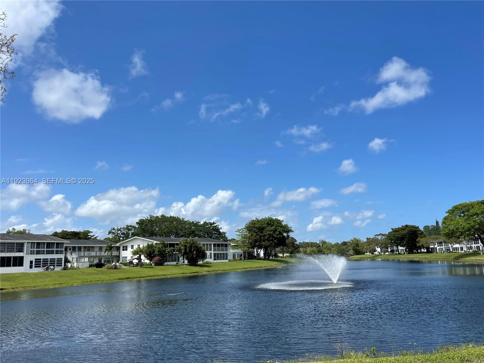 119 Tilford F, Unit 119 Deerfield Beach, FL 33442 - Photo 1 of 36 a view of a lake with houses