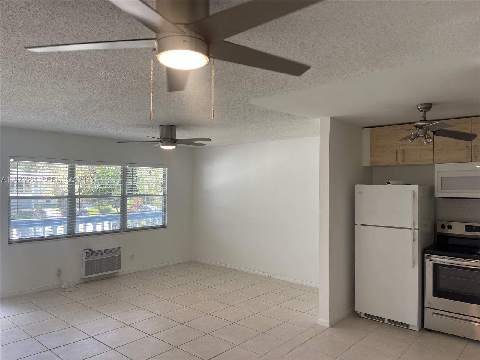 119 Tilford F, Unit 119 Deerfield Beach, FL 33442 - Photo 12 of 36 a view of an empty room with a window