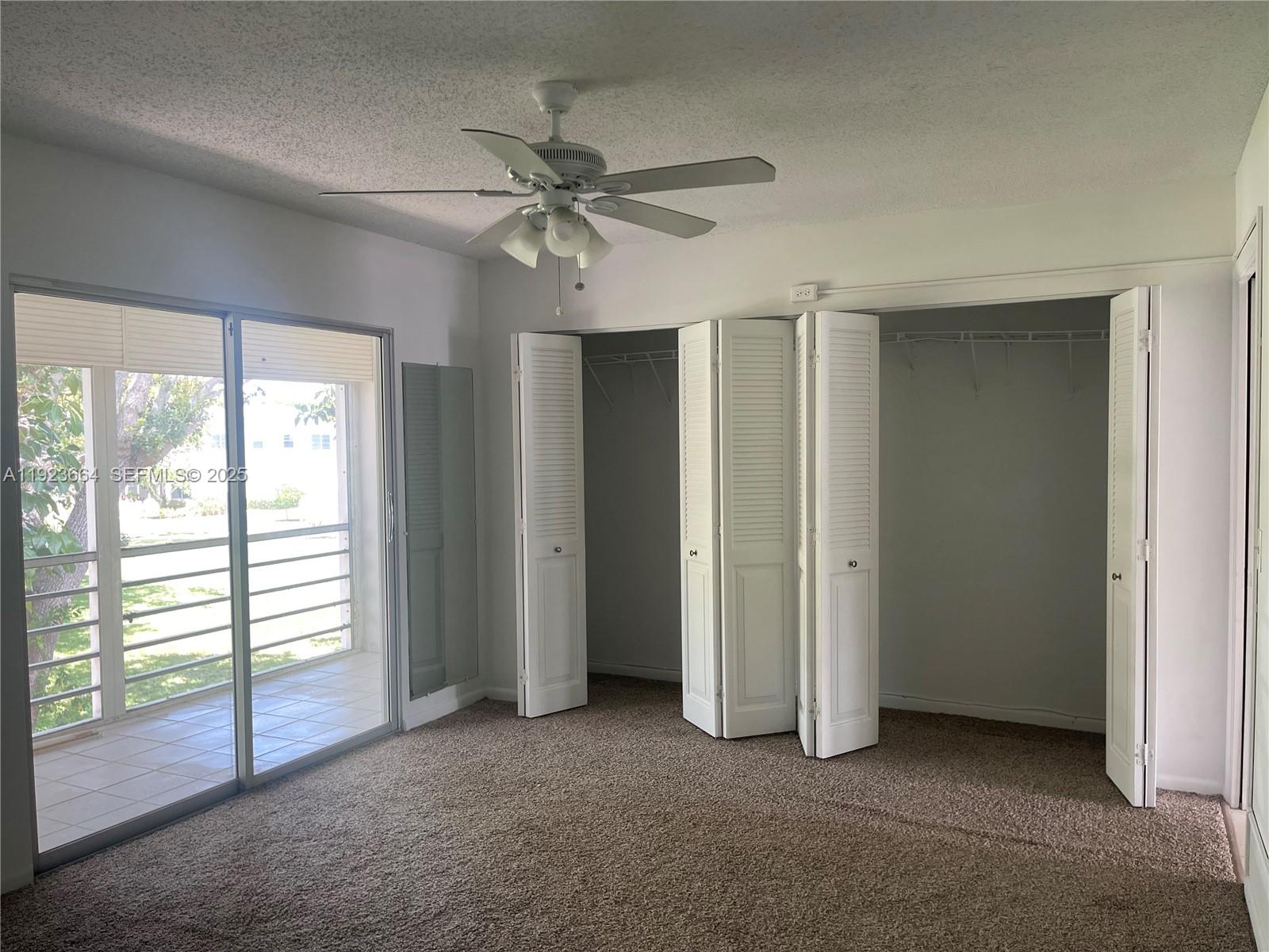 119 Tilford F, Unit 119 Deerfield Beach, FL 33442 - Photo 18 of 36 an empty room with windows and fan