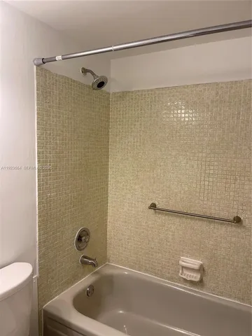 a bathroom with a shower and a toilet