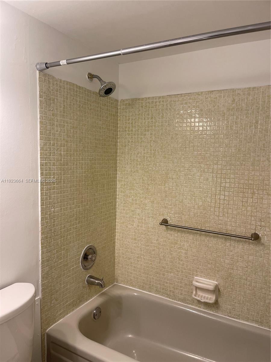 119 Tilford F, Unit 119 Deerfield Beach, FL 33442 - Photo 20 of 36 a bathroom with a shower and a toilet