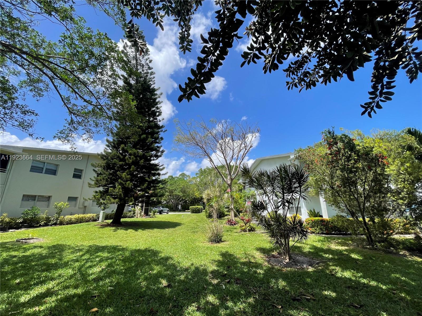 119 Tilford F, Unit 119 Deerfield Beach, FL 33442 - Photo 2 of 36 a view of a house with a yard