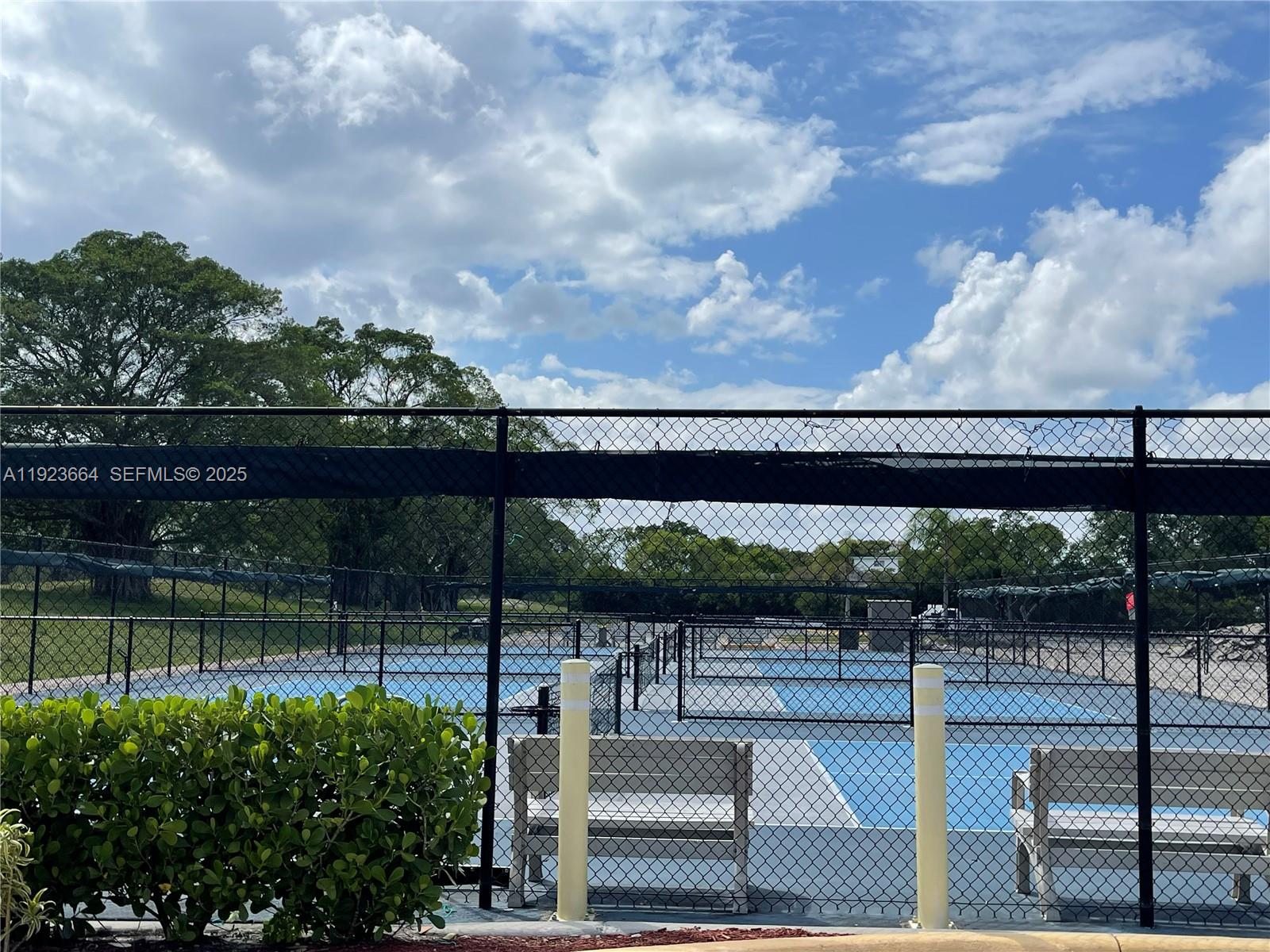 119 Tilford F, Unit 119 Deerfield Beach, FL 33442 - Photo 23 of 36 a view of a swimming pool with a patio
