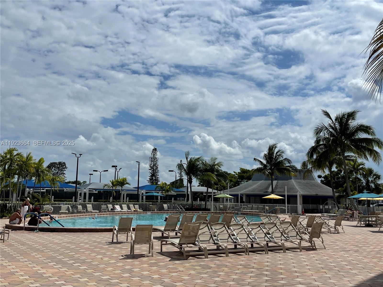 119 Tilford F, Unit 119 Deerfield Beach, FL 33442 - Photo 25 of 36 a view of a lake with a table and chairs