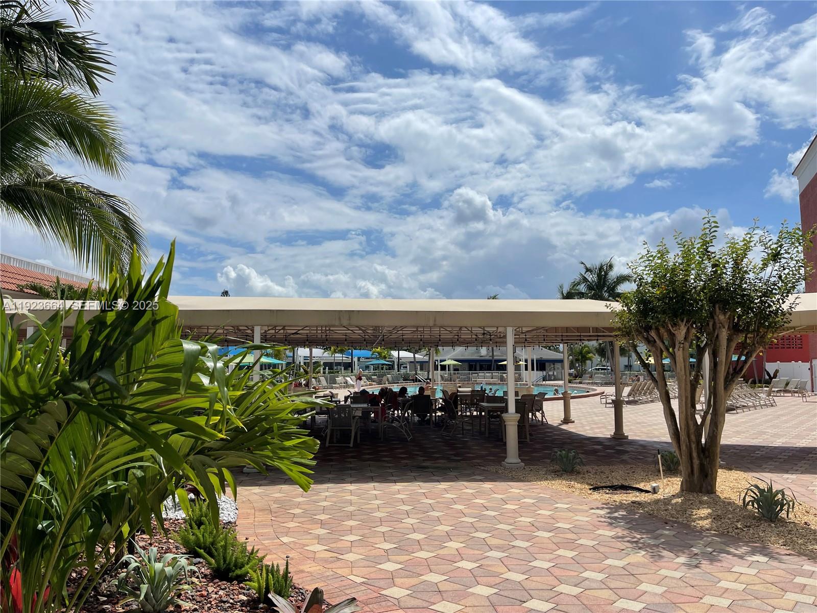 119 Tilford F, Unit 119 Deerfield Beach, FL 33442 - Photo 26 of 36 a view of a chairs and table in patio
