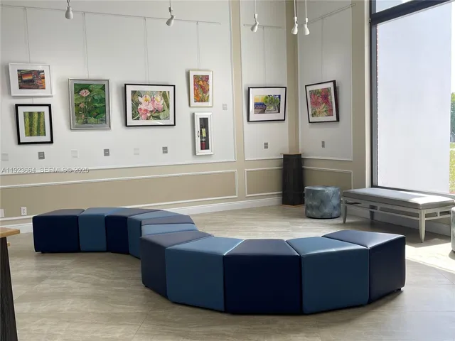 a living room with couches and painting on the wall