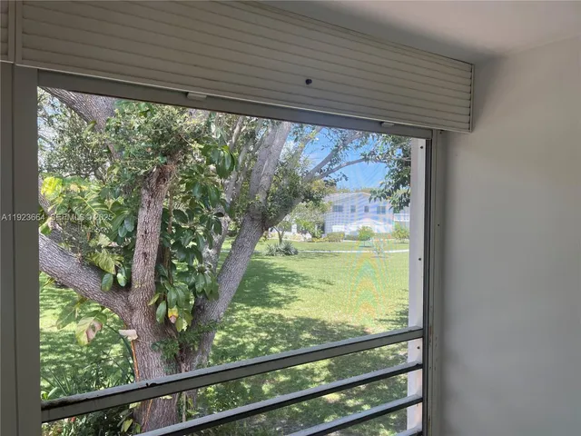 a view of a room with wooden floor and outdoor space