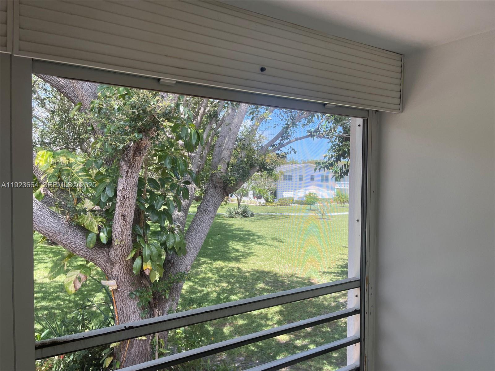 119 Tilford F, Unit 119 Deerfield Beach, FL 33442 - Photo 4 of 36 a view of a room with wooden floor and outdoor space