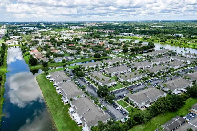 an aerial view of residential houses with outdoor space and trees