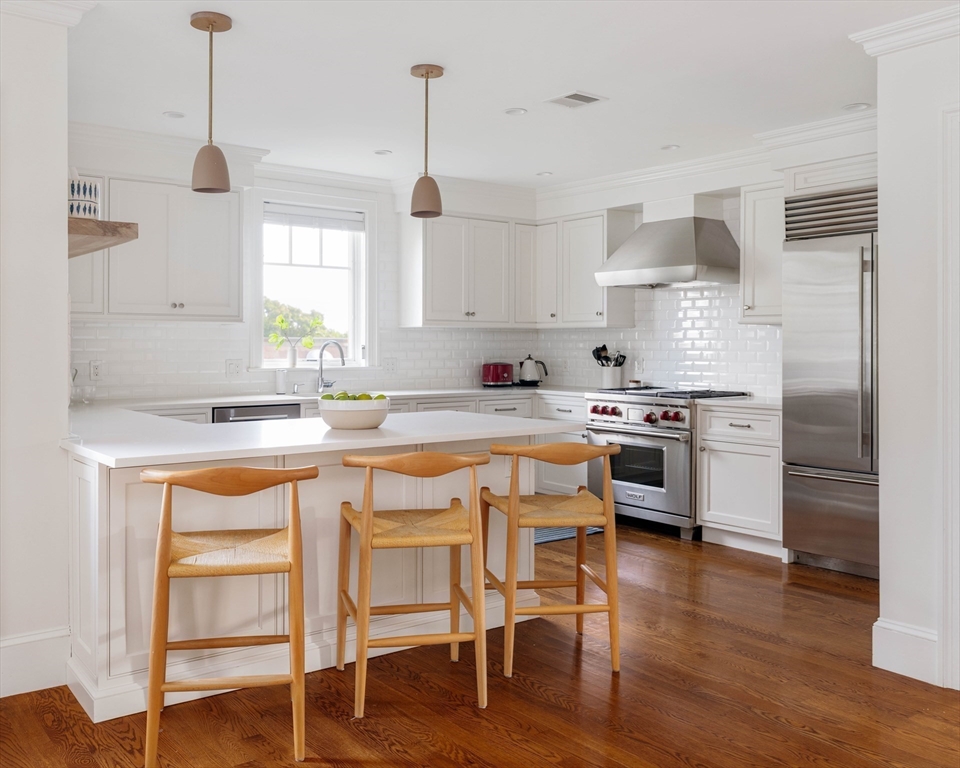 27 Summit Avenue, Unit 2 Brookline, MA 02446 - Photo 12 of 34 a kitchen with stainless steel appliances granite countertop a stove a sink and a refrigerator