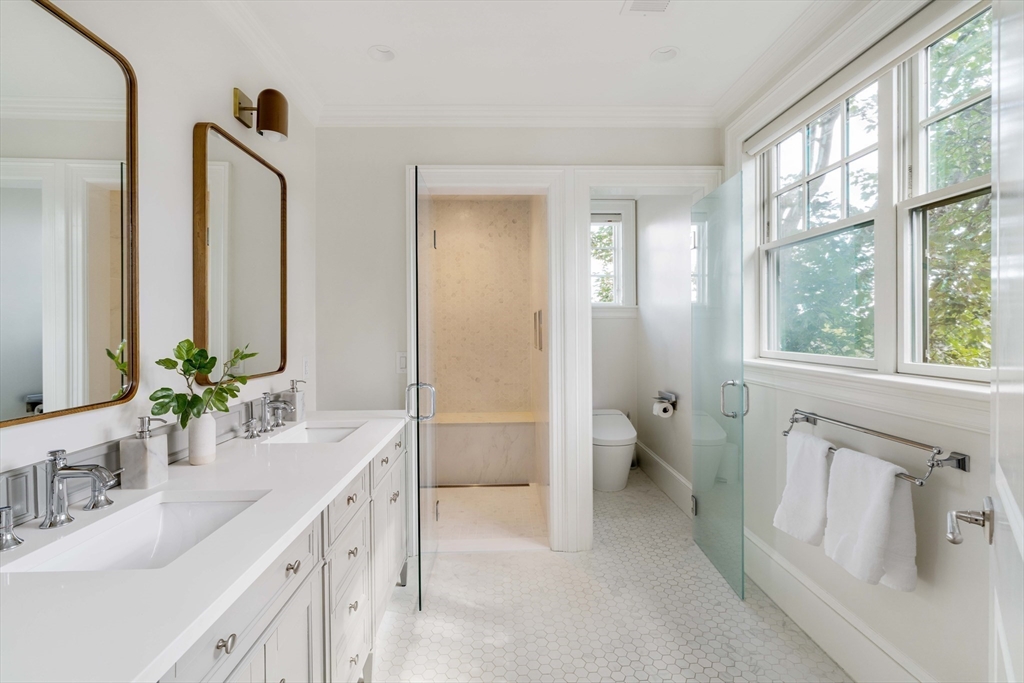 27 Summit Avenue, Unit 2 Brookline, MA 02446 - Photo 19 of 34 a bathroom with a double vanity sink and a mirror