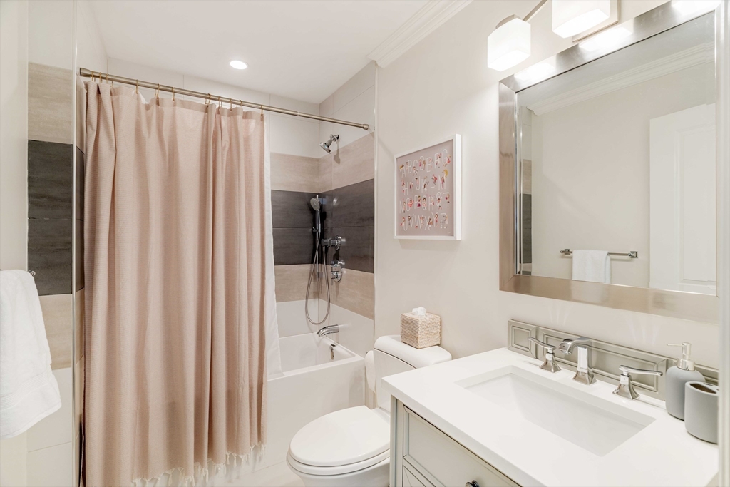 27 Summit Avenue, Unit 2 Brookline, MA 02446 - Photo 26 of 34 a bathroom with a sink toilet and shower